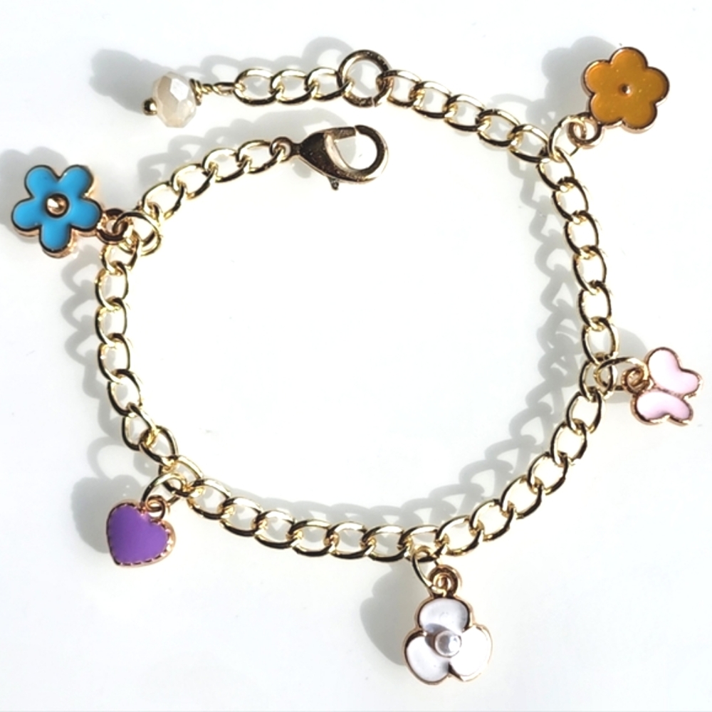 Charm bracelet. 6 inches with 1 inch extender. Gold w/ colorful charms.